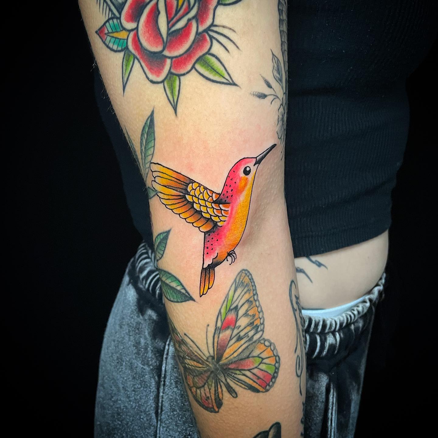 Colorful Aztec Hummingbird with Flowers on Arm