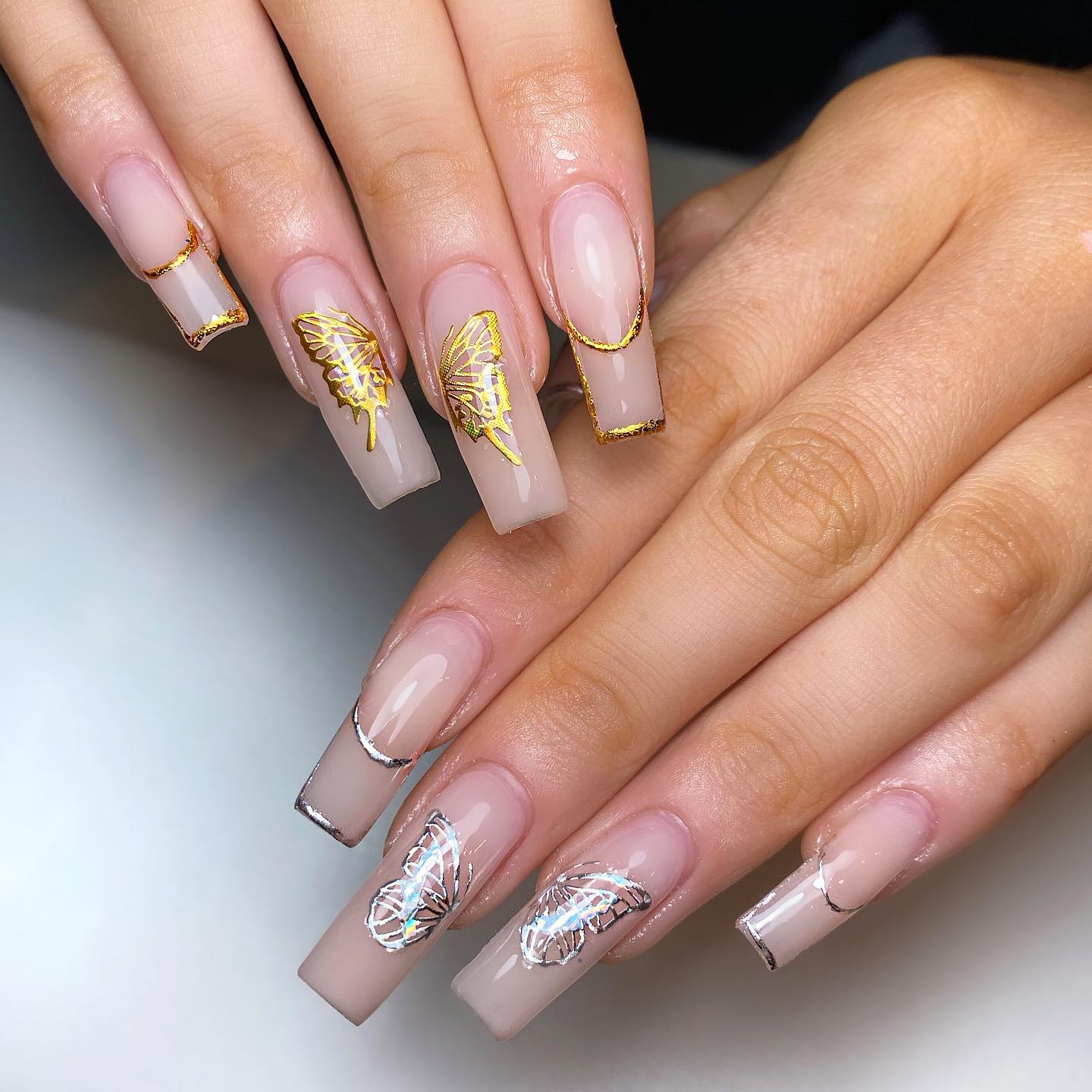 Long Square Nude Nails with Silver and Gold Butterfly Design