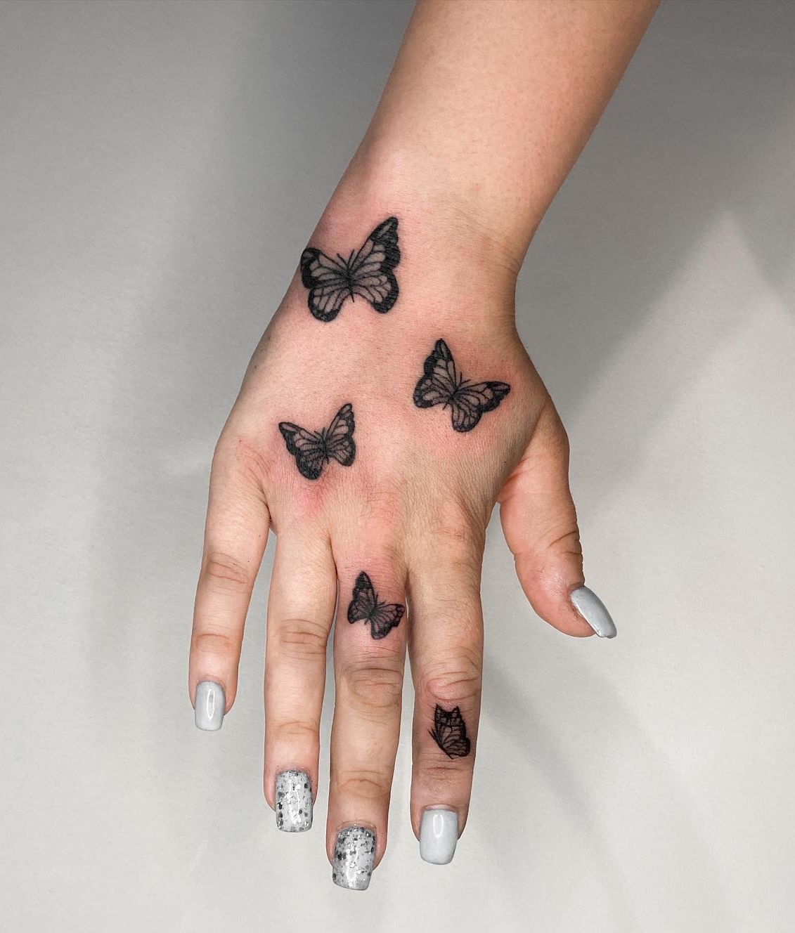 Butterfly hand and finger tattoo