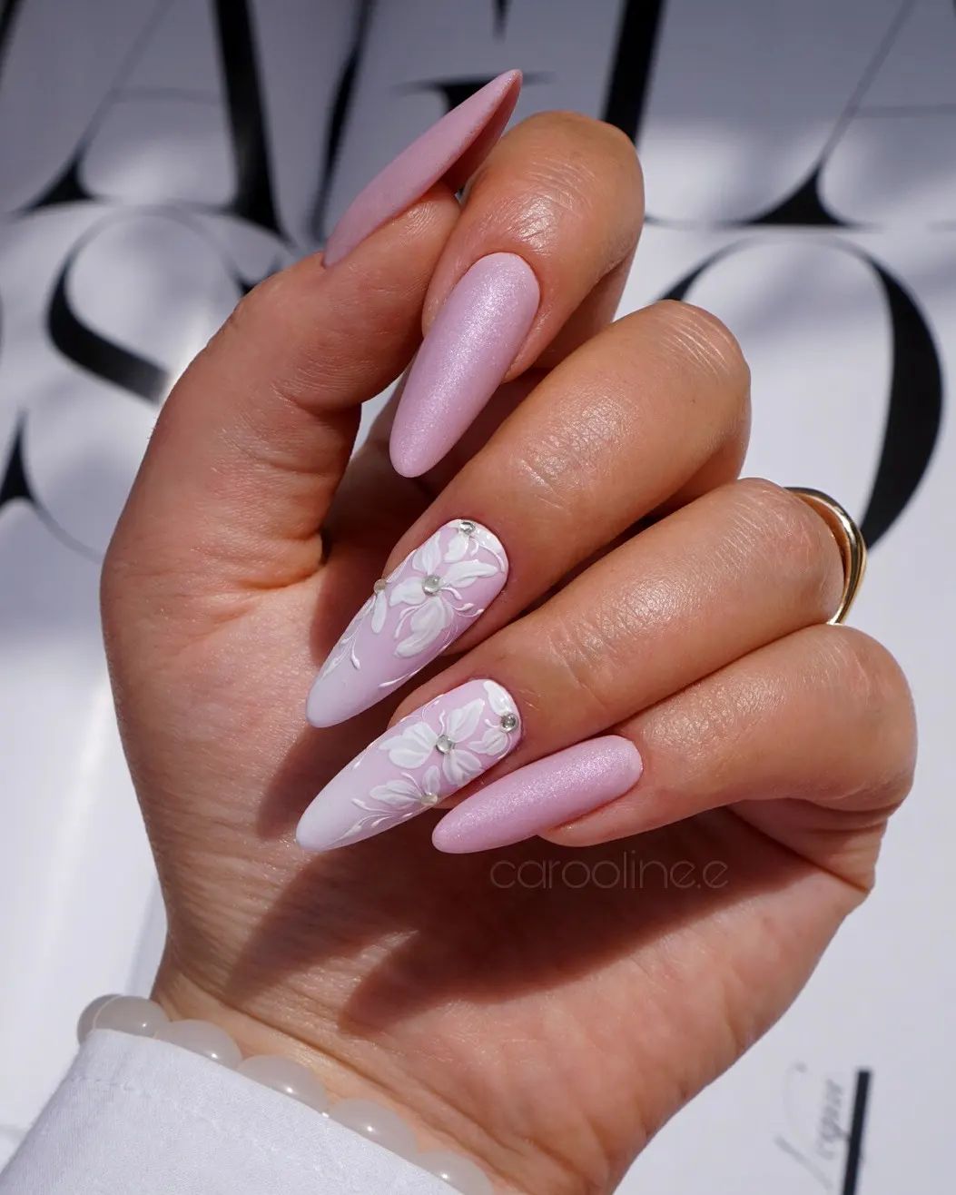 Long Almond Pink Nails with White Floral Design