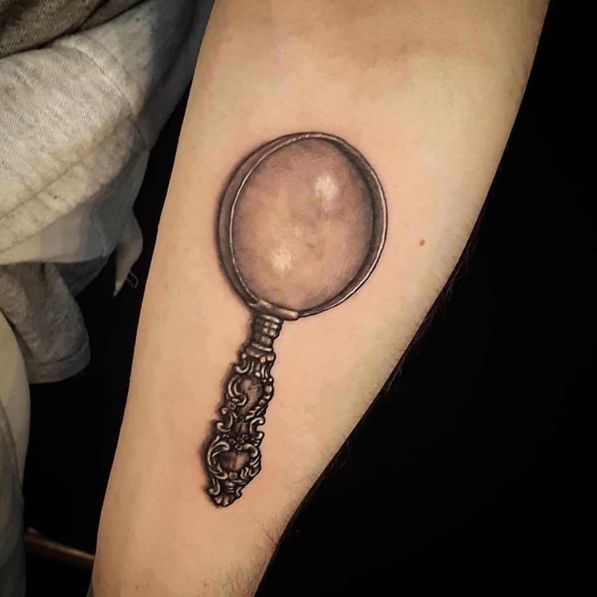 Black 3D Magnifying Glass Tattoo on Arm