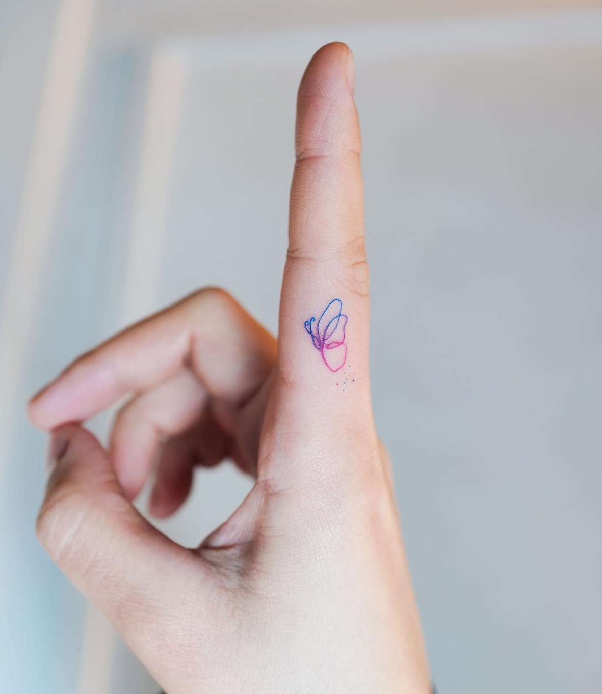 Colorful Butterfly tattoo finger